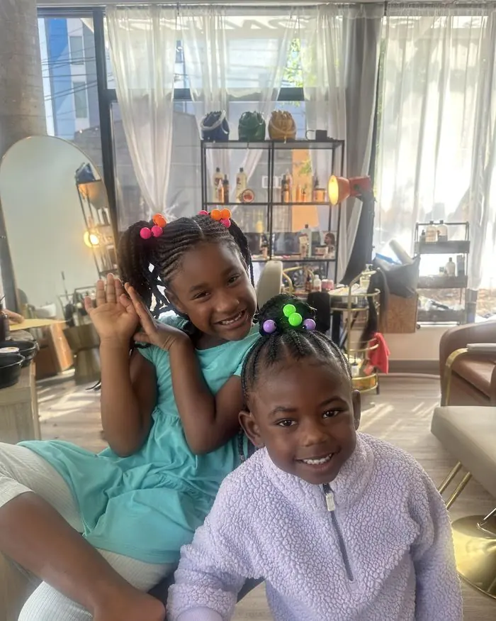 Two young clients with styled natural hair in the studio