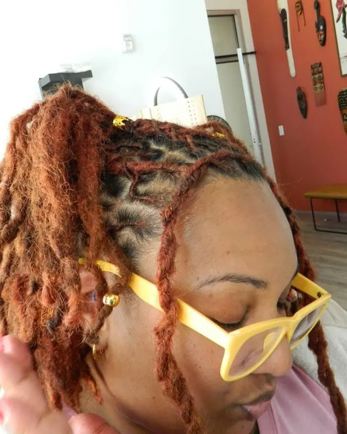 Copper-red locs dressed with gold cuffs