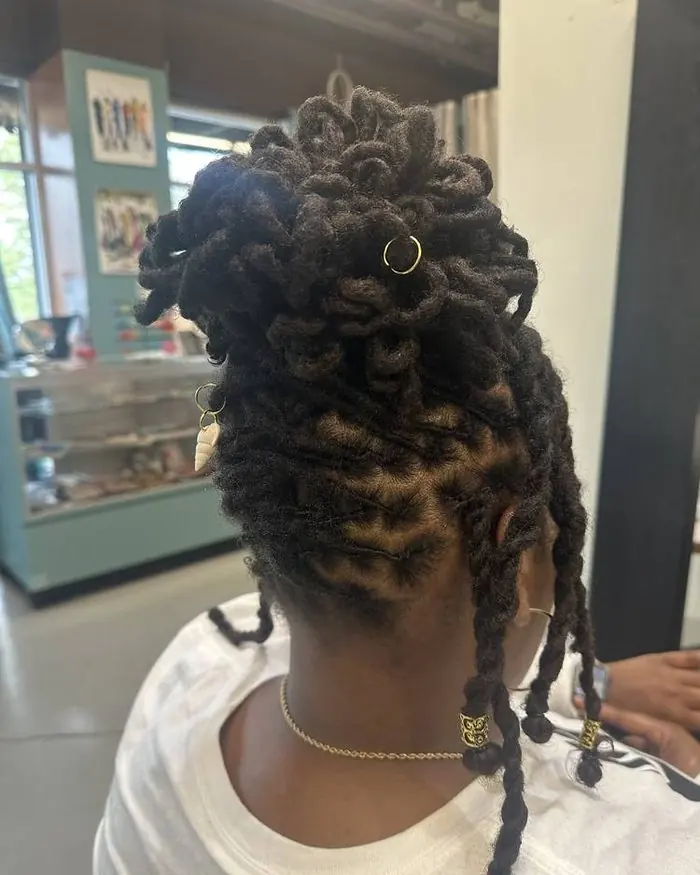 Loc updo with gold cuffs and coils