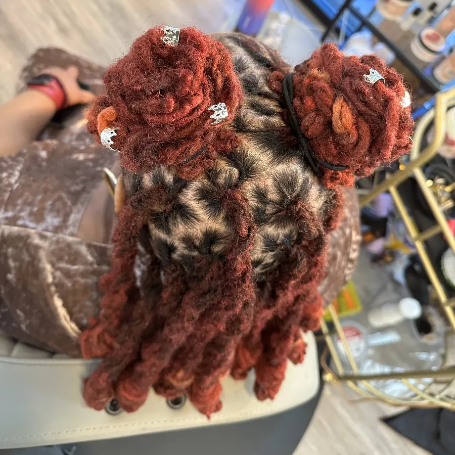 Burgundy loc knots with the curled ends falling loose