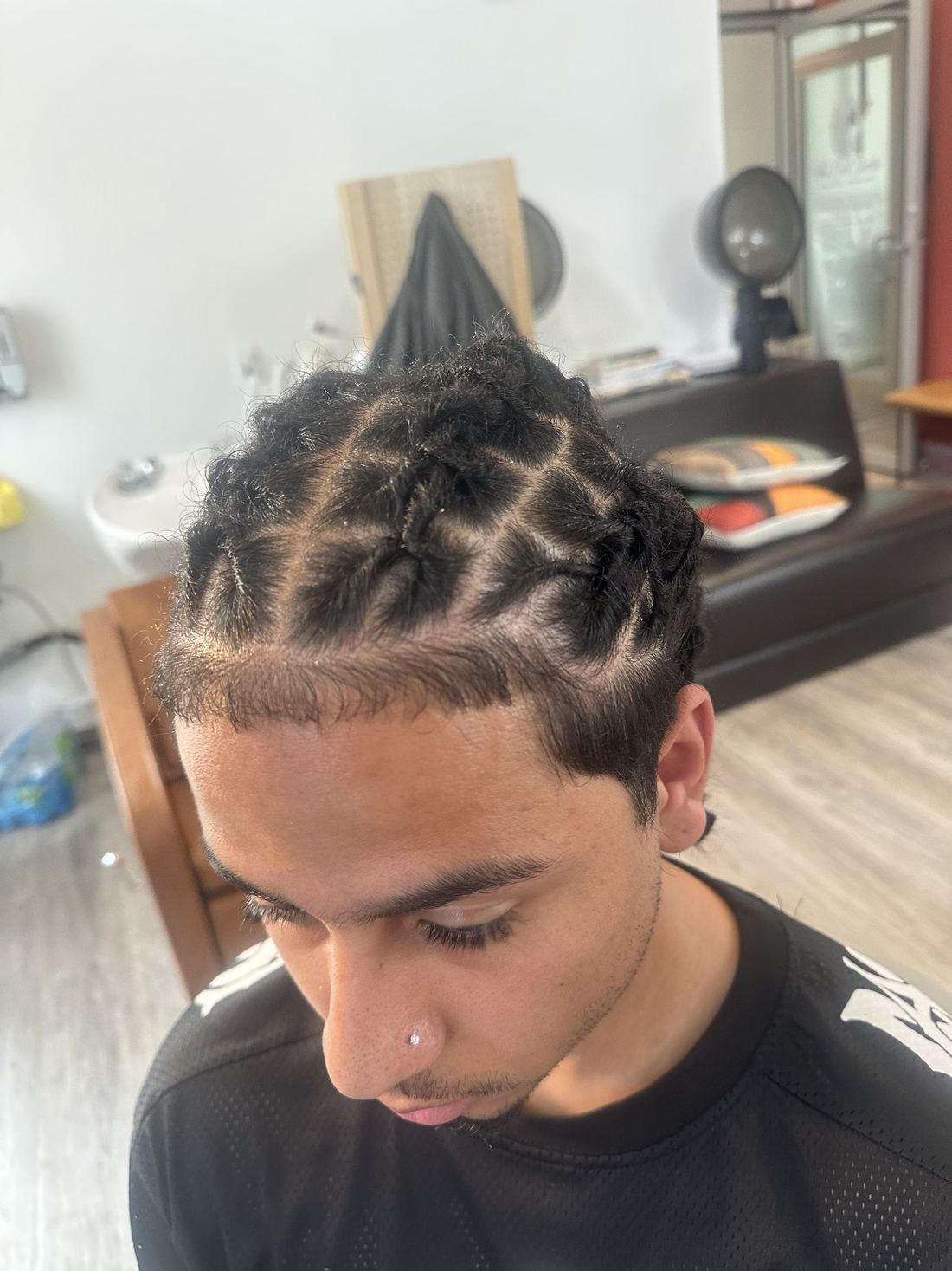 Young man with fresh, neatly sectioned locs